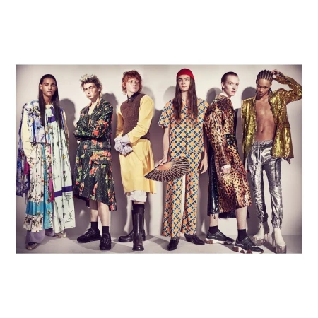 Six fashion models strike a pose in uniquely designed clothing, standing against a neutral backdrop in a fashion studio setting.