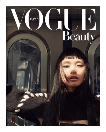 Portrait of a woman with dark hair and bangs wearing a black turtleneck against arched train windows by Marcus Ohlsson