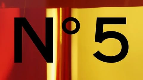 Graphic close-up of the black text 'N°5' set against red, gold, and yellow colored sections, creating a bold and modern abstract design.