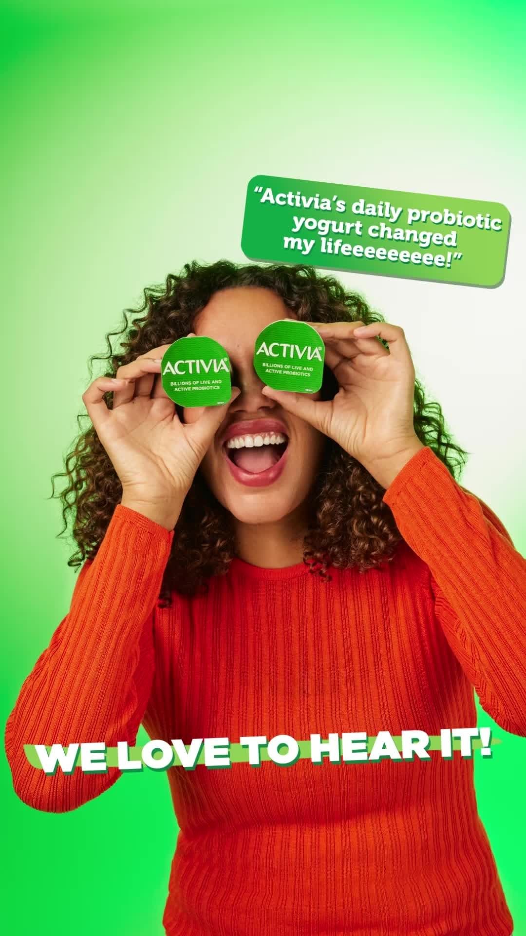 Woman smiles, holding Activia yogurt cups over her eyes against a bright green backdrop, as quote bubbles promote Activia’s health benefits.
