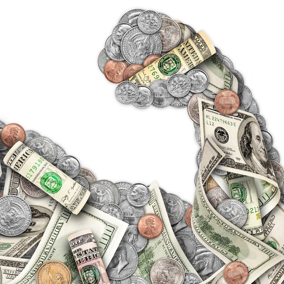 Money and currency arranged in the shape of a bicep, showcasing strength in finance and economy with dollar bills and coins.