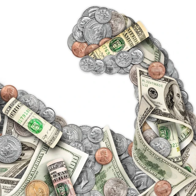 Money and currency arranged in the shape of a bicep, showcasing strength in finance and economy with dollar bills and coins.