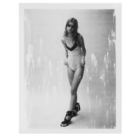 Monochrome portrait of a woman in sunglasses and a light one-piece swimsuit shot by Mariano Vivanco.
