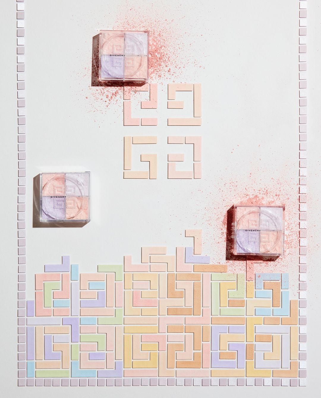 Givenchy face powders arranged like Tetris blocks on a white surface, with powdered pigment accents, creating a beauty product still life.