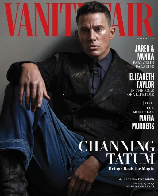 Channing Tatum in a magazine cover image. He is wearing a dark jacket with blue jeans, seated against a gray wall background.