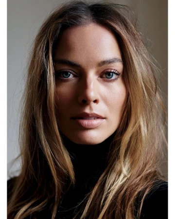 Close-up portrait of Margot Robbie with blonde hair and blue eyes wearing a dark turtleneck photographed by Mario Sorrenti.