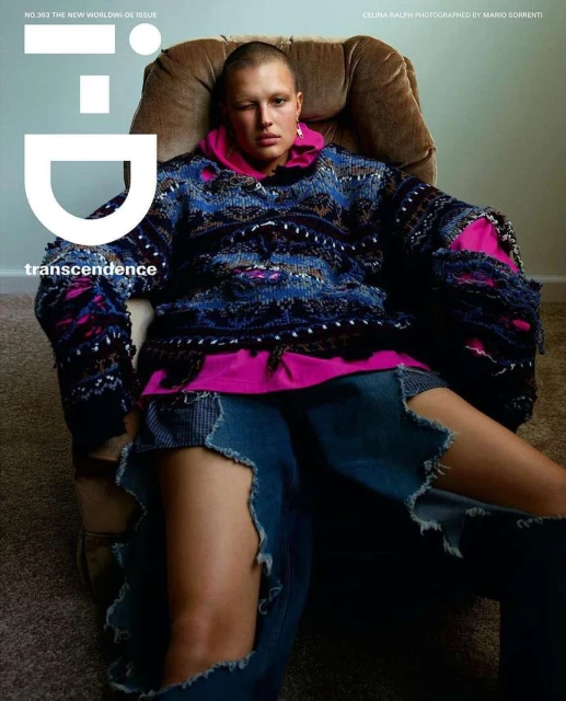 Magazine cover featuring a woman in a chair wearing a colorful sweater and distressed denim, photographed in a photo studio.