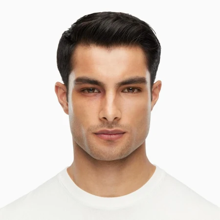 Portrait of an adult male with short dark hair and a white t-shirt, facing the camera, showing a bruise around his left eye.