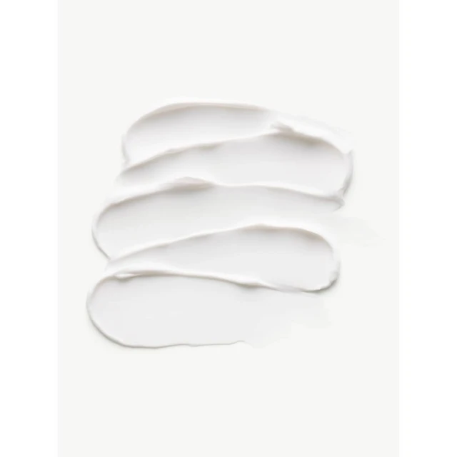 Close-up of white cream swatches creating textured strokes on a white backdrop, ideal for beauty or skincare product marketing.