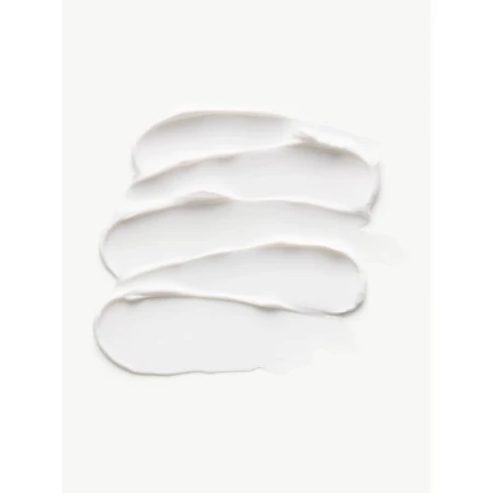 Close-up of white cream swatches creating textured strokes on a white backdrop, ideal for beauty or skincare product marketing.