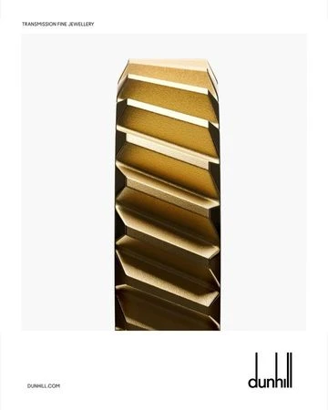 Angled gold band ring on a white background. Jewelry advertisement for Dunhill. Studio shot. Gold geometric ring.