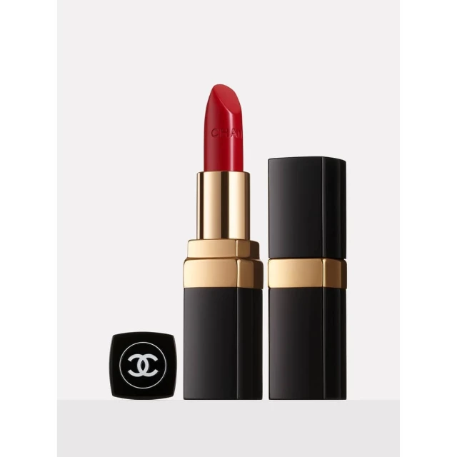 Close-up of red Chanel lipstick, showcasing its bold color and elegant design against a clean, neutral background.