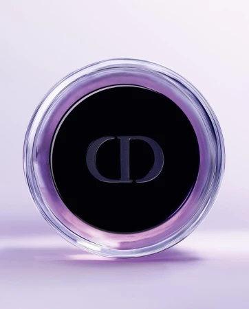 Close-up of a clear glass container with a black lid and the 'CD' logo, set against a soft lavender background, emphasizing beauty and luxury.