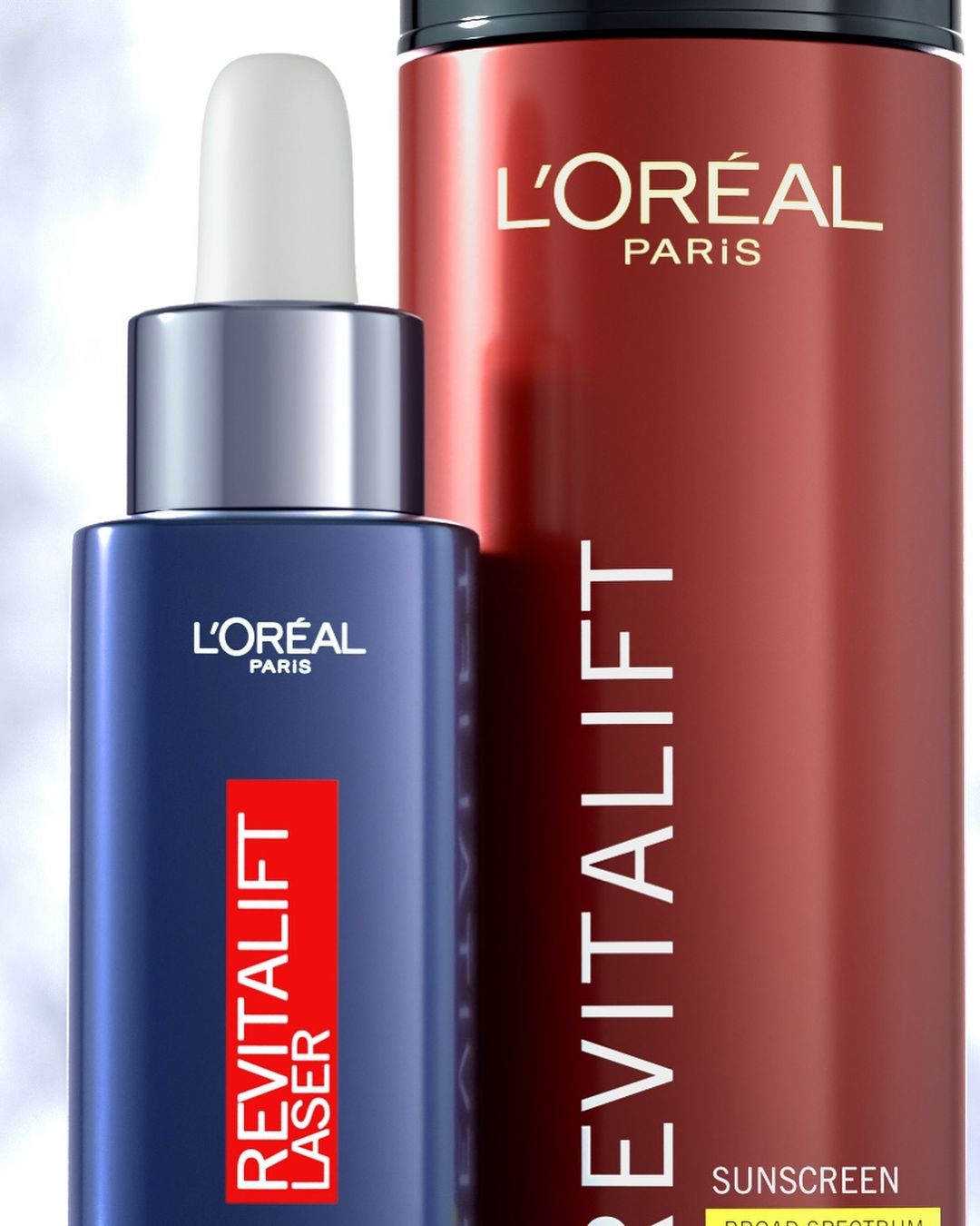 Close-up of L'Oréal Paris Revitalift skincare products in blue and red packaging, featuring a serum with a dropper and sunscreen.