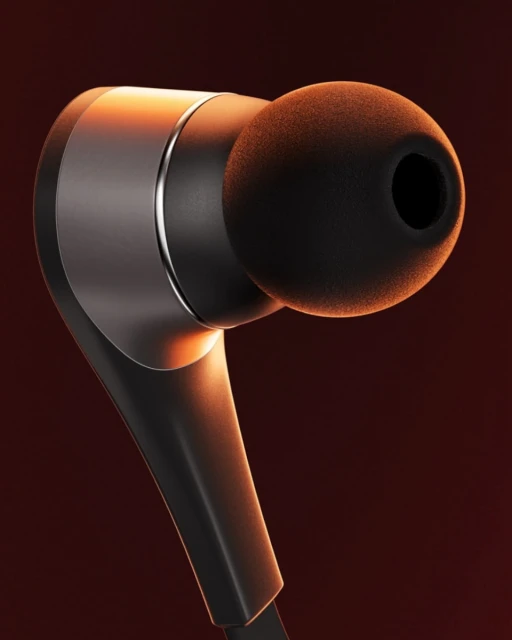 Close-up product shot of a single wireless earbud featuring a black ear tip and a shiny metallic accent on a warm, gradient background.