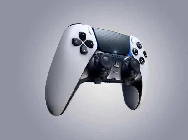 Floating PlayStation 5 DualSense Edge controller on a gray gradient background, showcasing its white and black design with signature buttons.