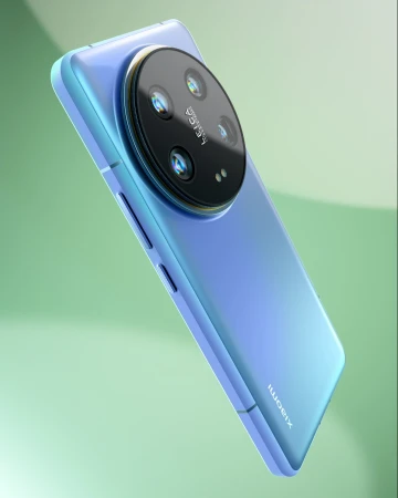 Close-up product shot of a light blue Xiaomi smartphone showcasing its circular multi-lens camera on a soft green gradient background.