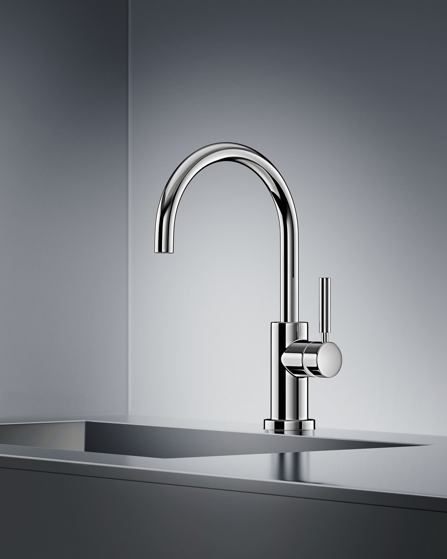 Close-up studio shot of a modern chrome faucet mounted on a countertop, set against a gradient grey backdrop.