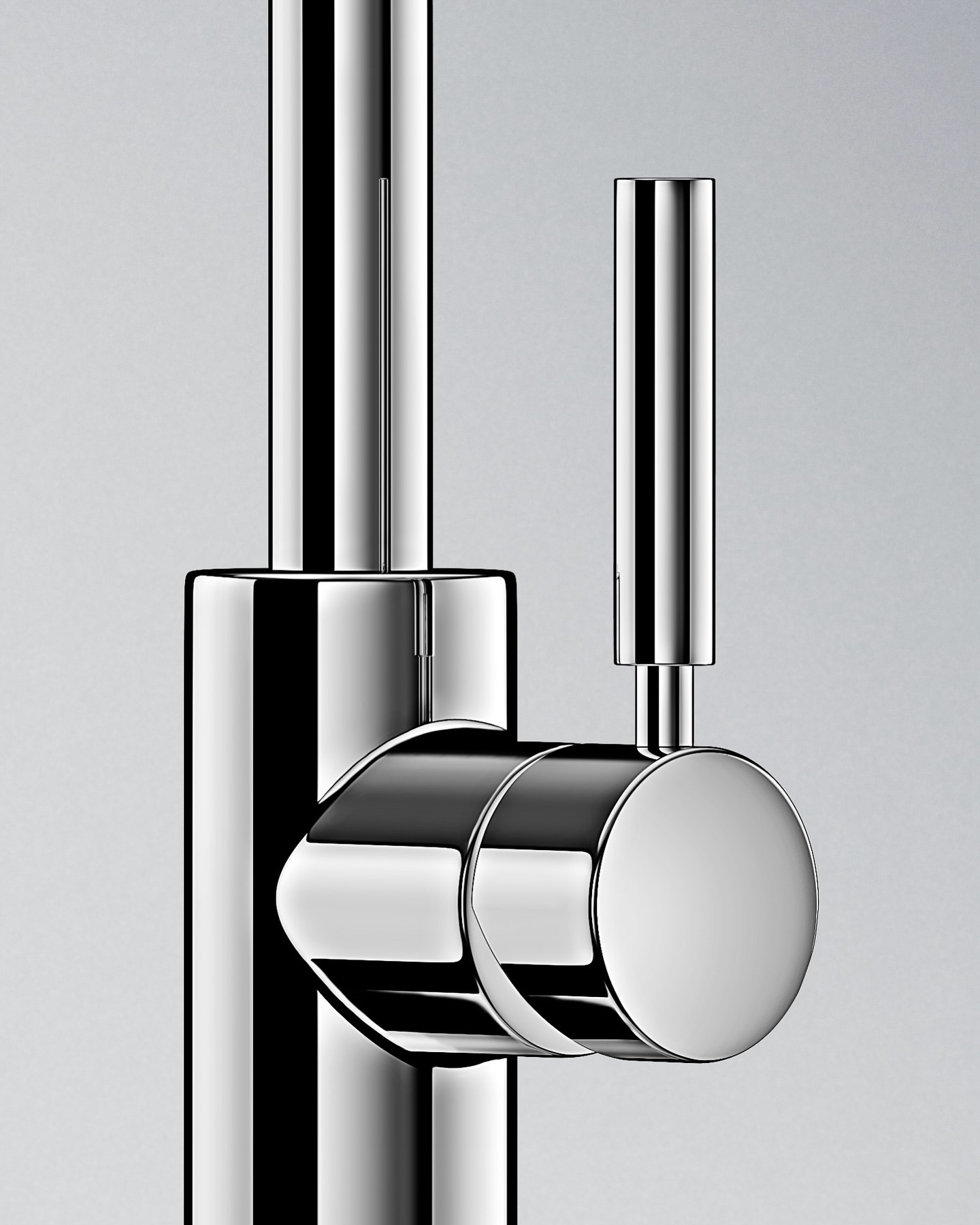Close-up studio shot of a sleek, chrome faucet with cylindrical handle, highlighting its modern design and polished finish against a neutral background.