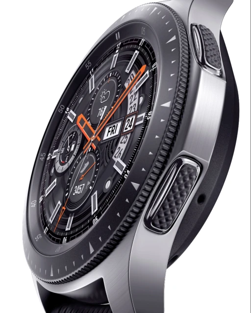 Smartwatch close-up featuring a silver band and a black face with orange and white details, displaying date and time information.