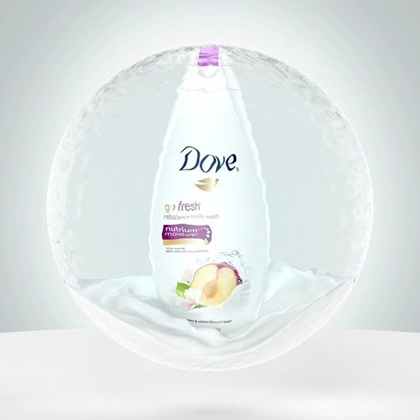 Dove body wash bottle with plum illustration inside a water bubble, promoting skincare and personal care on a light grey background.