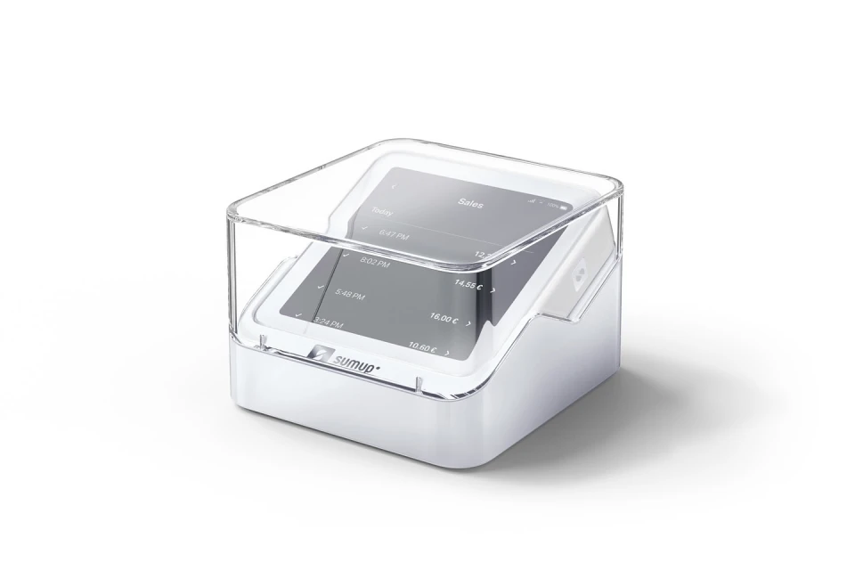 Modern payment terminal in a protective clear case, showcasing digital sales data on the screen, on a white surface.