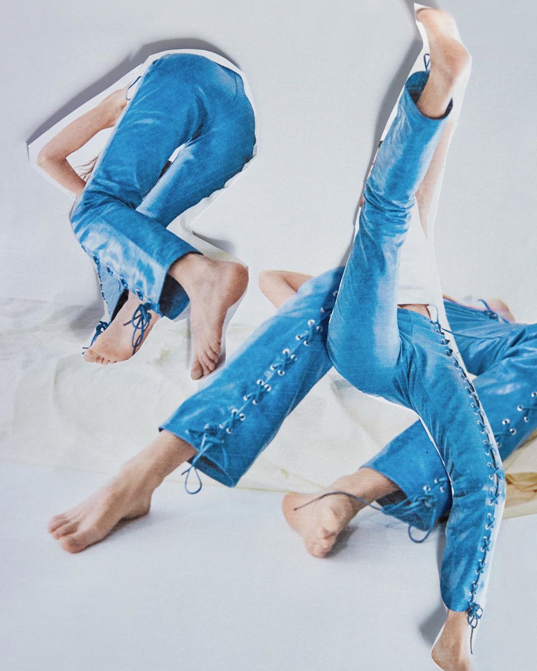 Fashion shot features multiple exposures of a person wearing blue lace-up pants, with bare feet, against a white background.