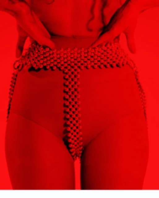 Close-up on the midsection of an adult, clad in a red swimsuit and a beaded belt, set against a monochromatic red background.