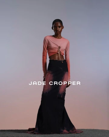 Model wearing a pink ombre long-sleeve top and black floor-length skirt in a studio setting by Mariya Pepelanova