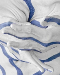 Close-up of pale skin painted with flowing blue stripes, featuring intertwined hands in a creative pose.
