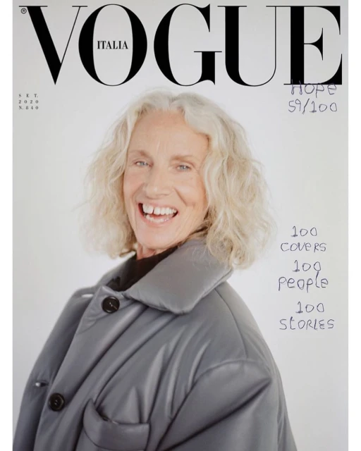 Vogue Italia cover featuring smiling mature adult female with grey hair wearing a grey button-down jacket on a white background.