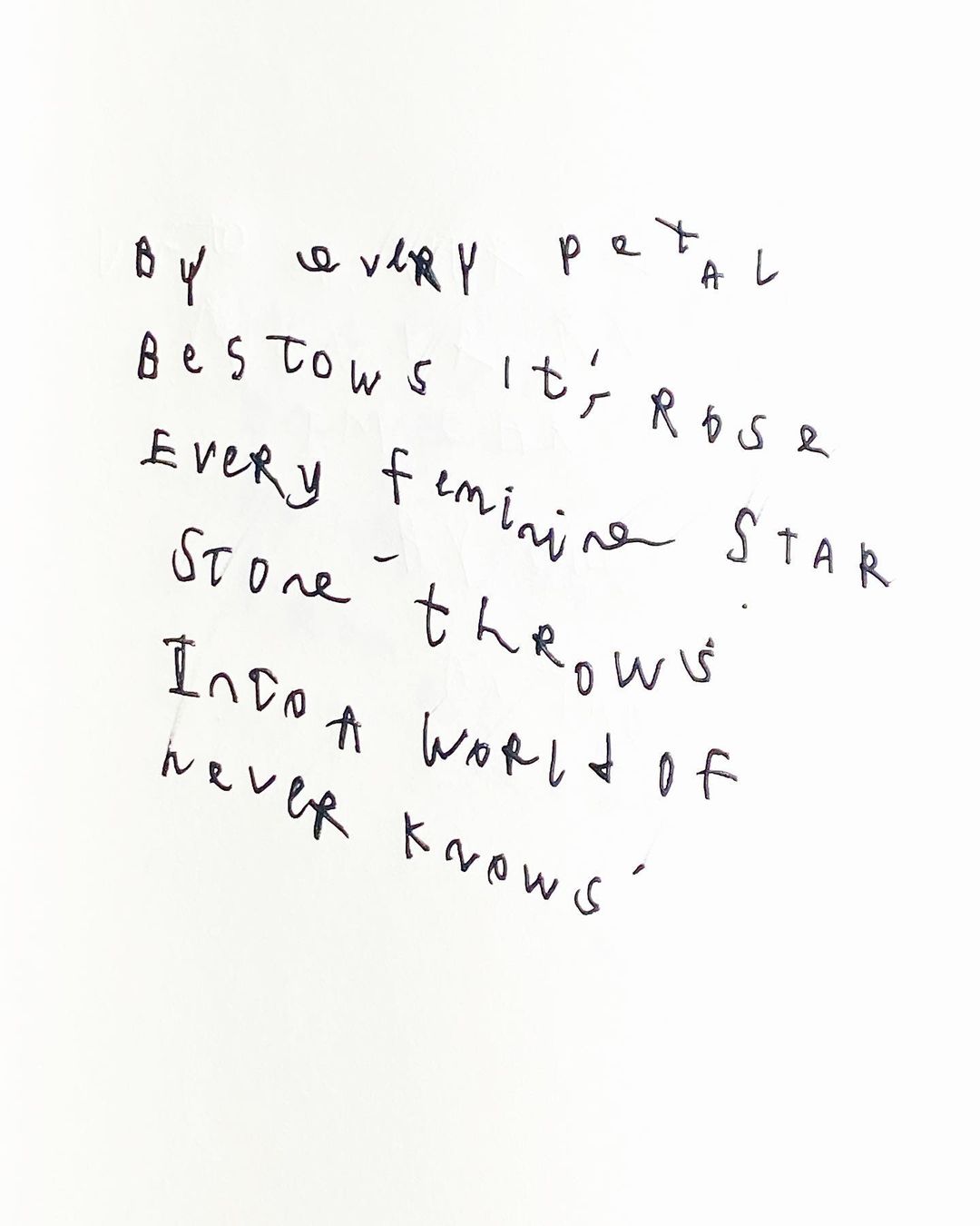 Close-up of handwritten poem on white background. Black ink script spells out verses with artistic imperfections and character.