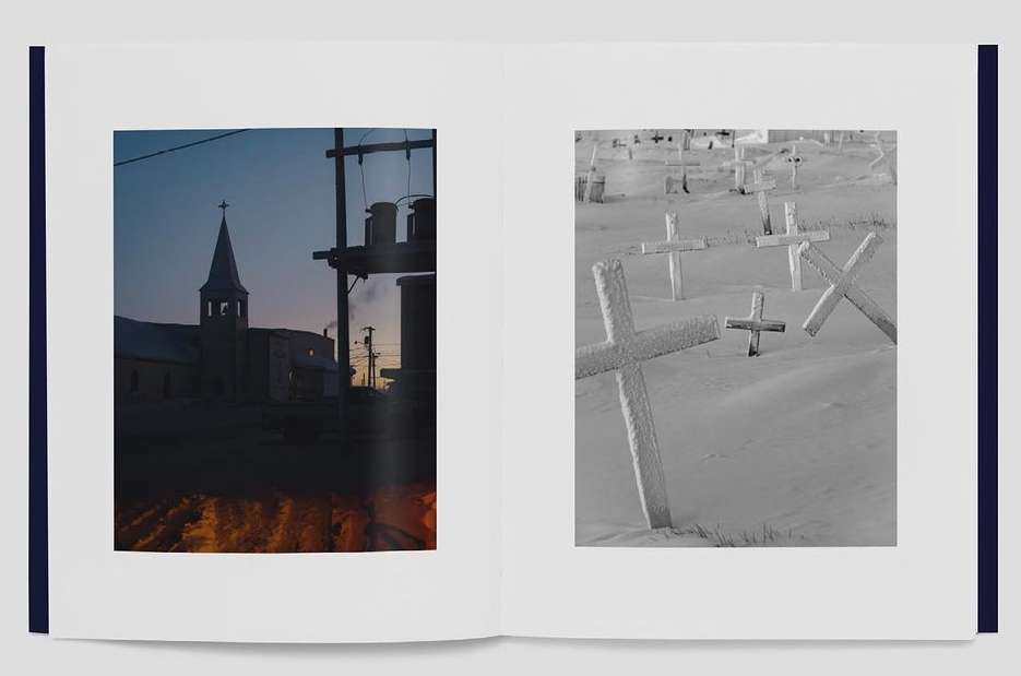 Image of an open book featuring a black-and-white photo of a church and a snowy graveyard with crosses displayed side by side.