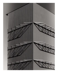 Monochrome architectural photograph of an industrial building exterior with corrugated metal siding and geometric structural overhangs.