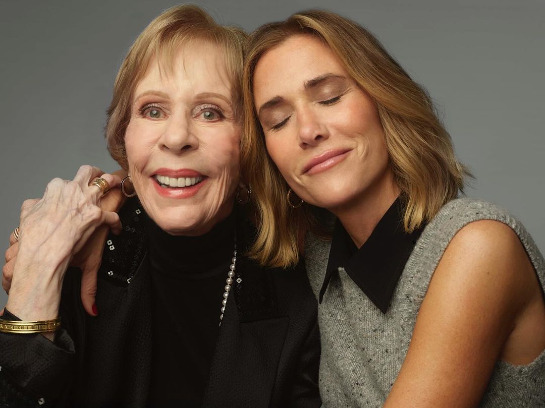 Close-up of Carol Burnett with an adult woman. Burnett is smiling and wearing a black jacket. The other woman is fair-skinned.
