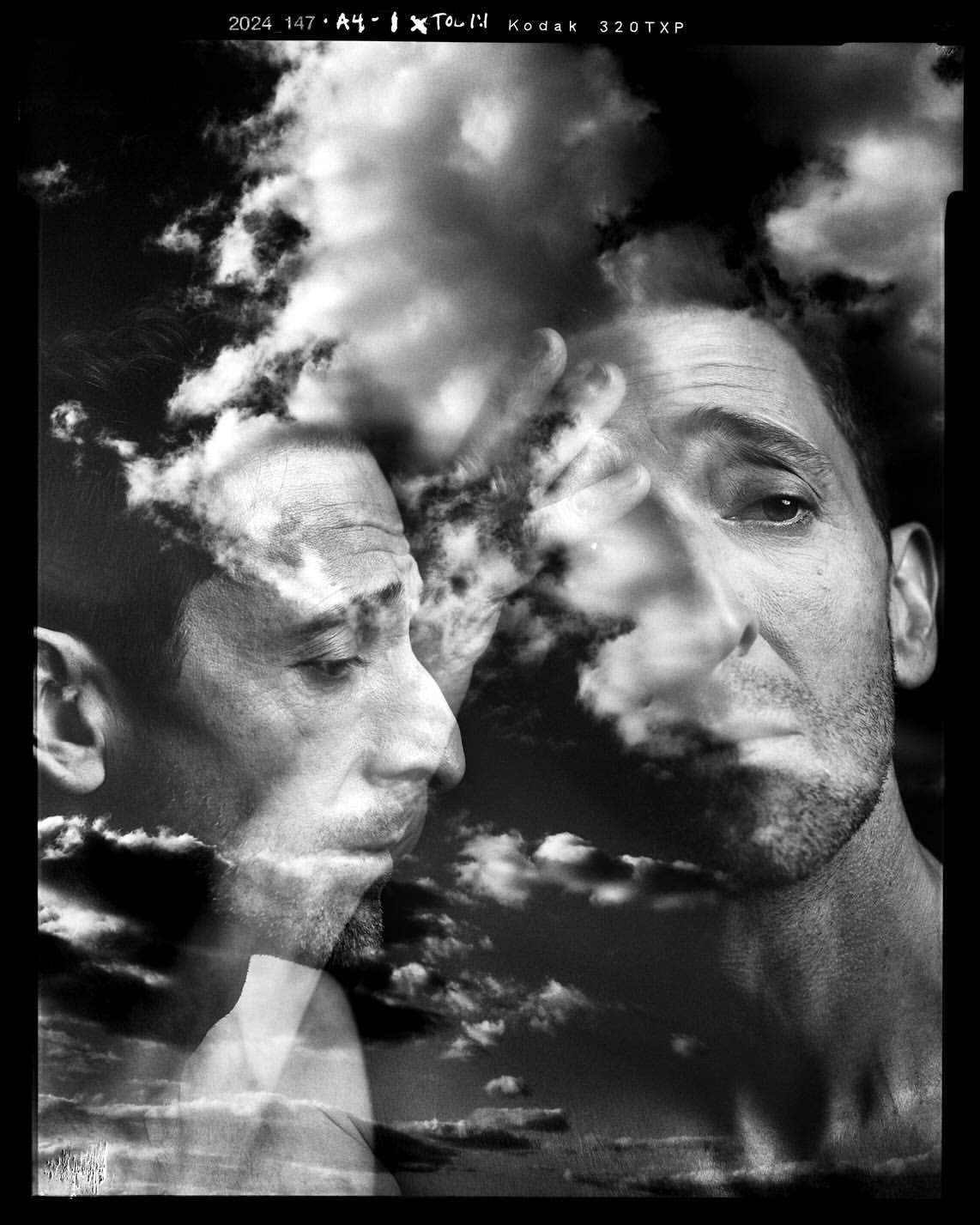 Black and white double exposure featuring an adult male's portrait blended with dramatic clouds, creating a surreal, artistic composition.