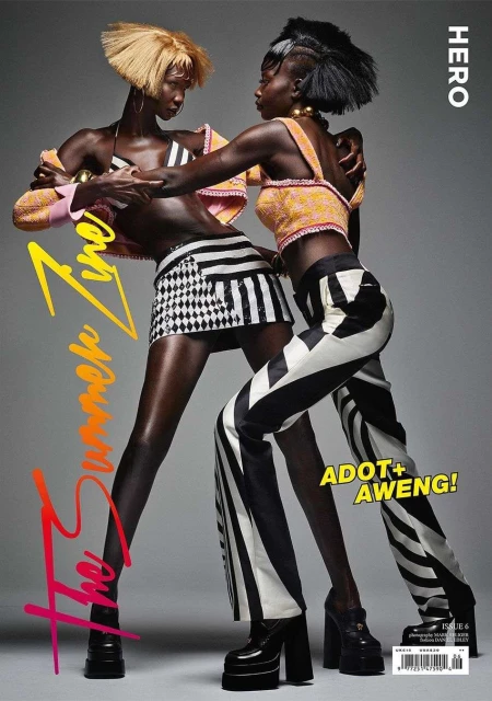 Magazine cover featuring two Black fashion models in eye-catching outfits, posing in a studio with the magazine's title and issue number.