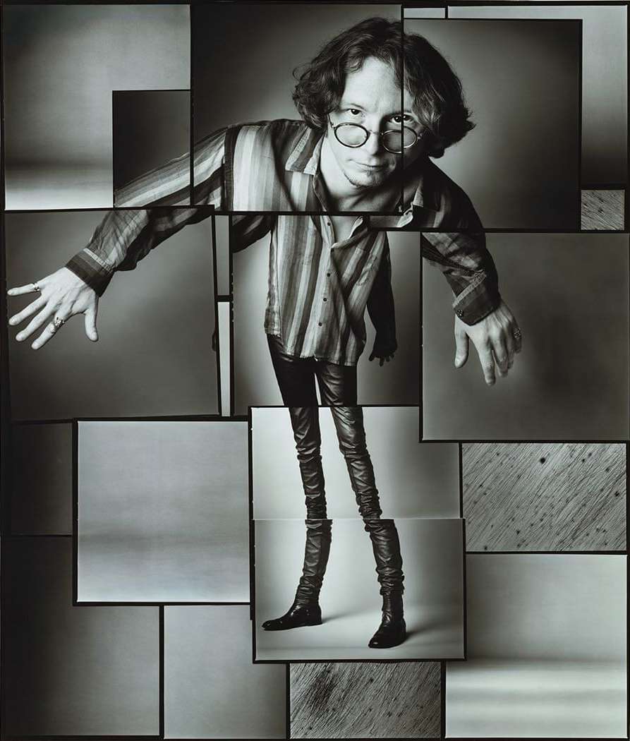 Black and white photographic art of a single adult male with glasses in a striped shirt, leather pants, and boots, collage style.