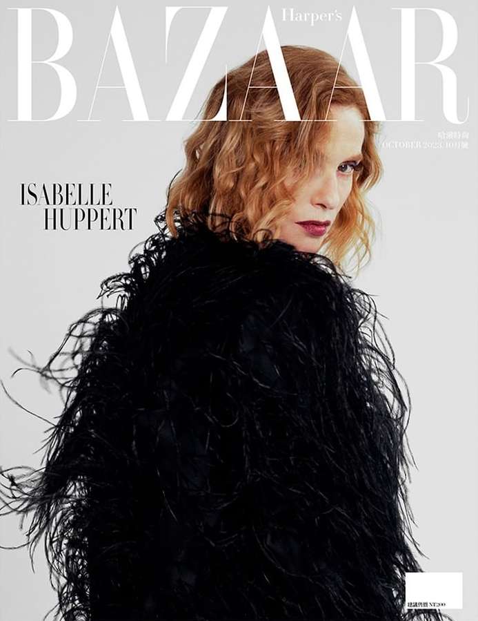 Magazine cover featuring Isabelle Huppert wearing a black feathered jacket against a neutral backdrop, with the 'Harper's Bazaar' masthead.