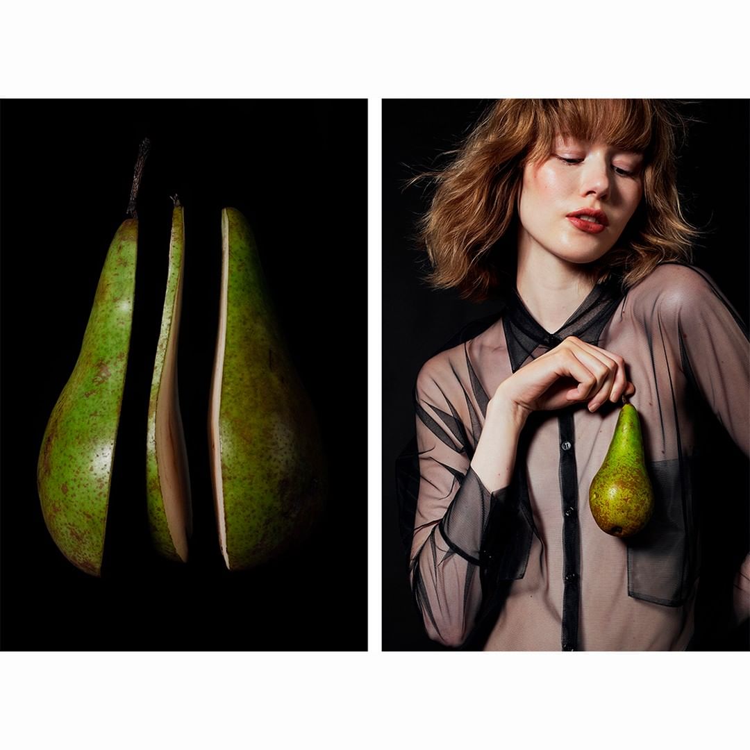 Sliced pear and a young woman with a pear in a sheer black shirt against a dark backdrop, showcasing a blend of food and fashion.