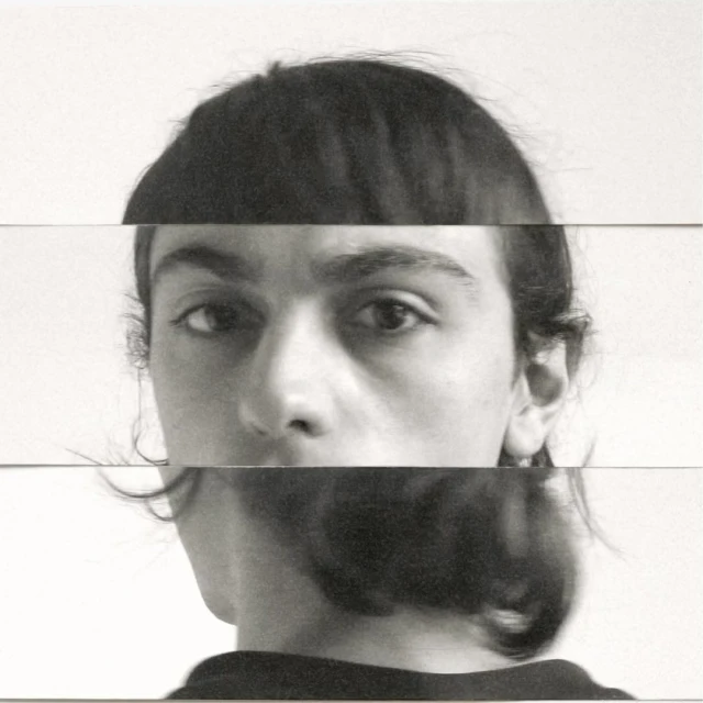 Abstract portrait of a person's face fragmented into horizontal bands on a white background, creating a surreal, distorted aesthetic.