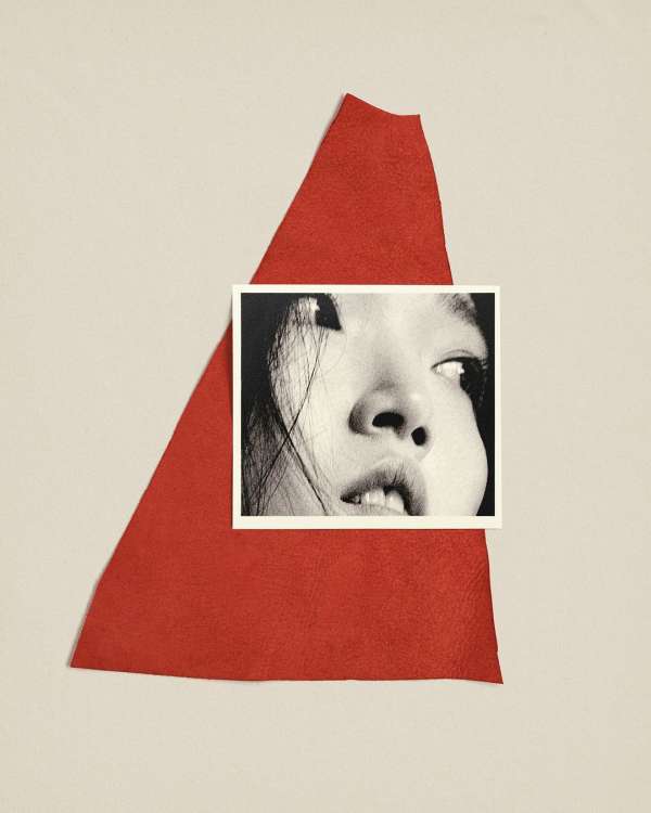 Black and white portrait photo of a person placed on a red leather triangle against an off-white backdrop.