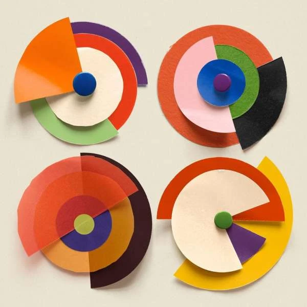 Geometric paper art featuring colorful layered circles and semi-circles in a square layout, creating a vibrant and abstract design.