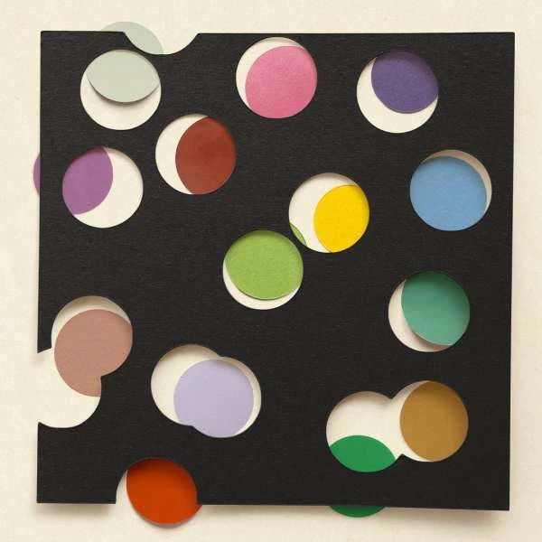 Abstract art features black square with die-cut holes revealing circles in shades of green, blue, purple, pink, red, and yellow.
