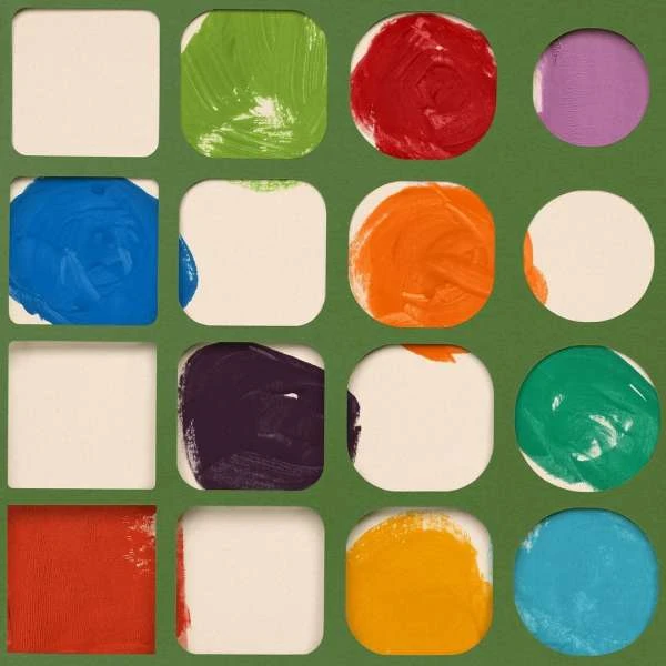 Arrangement of painted squares and circles in a variety of colors against a green background, creating an abstract and colorful pattern.