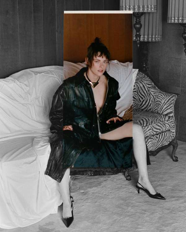Stylish woman in a black jacket poses on a sofa and chair split between color and grayscale, creating a unique vintage aesthetic.