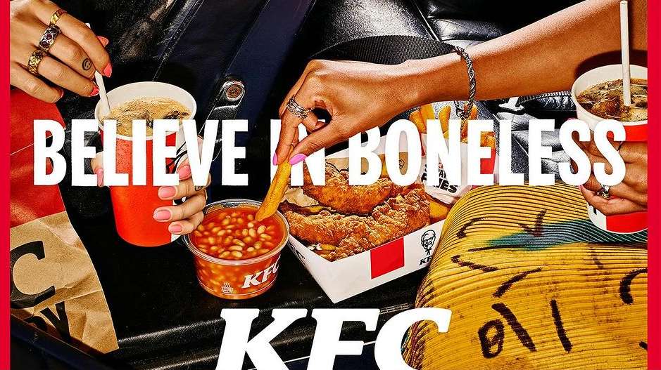Close-up of two women's hands holding KFC fast food, including fried chicken, french fries, beans, and drinks, with bold text overlay.