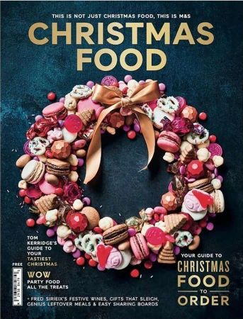 Christmas food wreath made of cookies and candy, tied with a gold ribbon, against a dark blue background for a magazine cover.