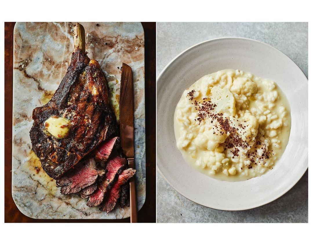 Overhead shot of a Tomahawk steak cooked medium-rare, served with butter on a marble cutting board, paired with cauliflower puree.