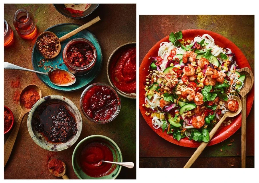 Overhead food photography: Thai shrimp salad with rice noodles, chili garlic sauce, and various vibrant ingredients.